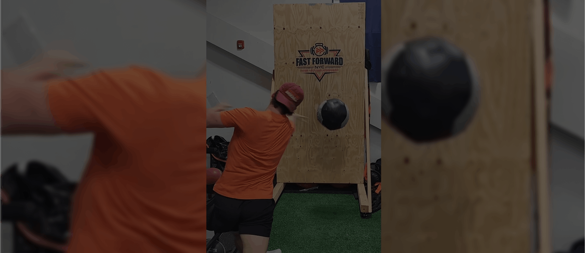 Person throwing a ball at a target board in an indoor game area.