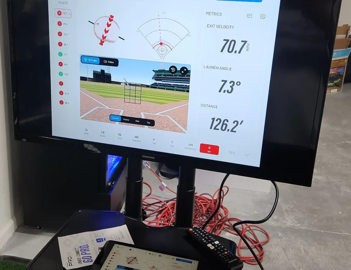 Monitor displaying golf shot data with trajectory and statistics.