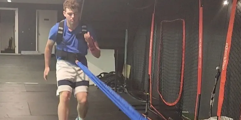 Athlete training with resistance bands indoors.
